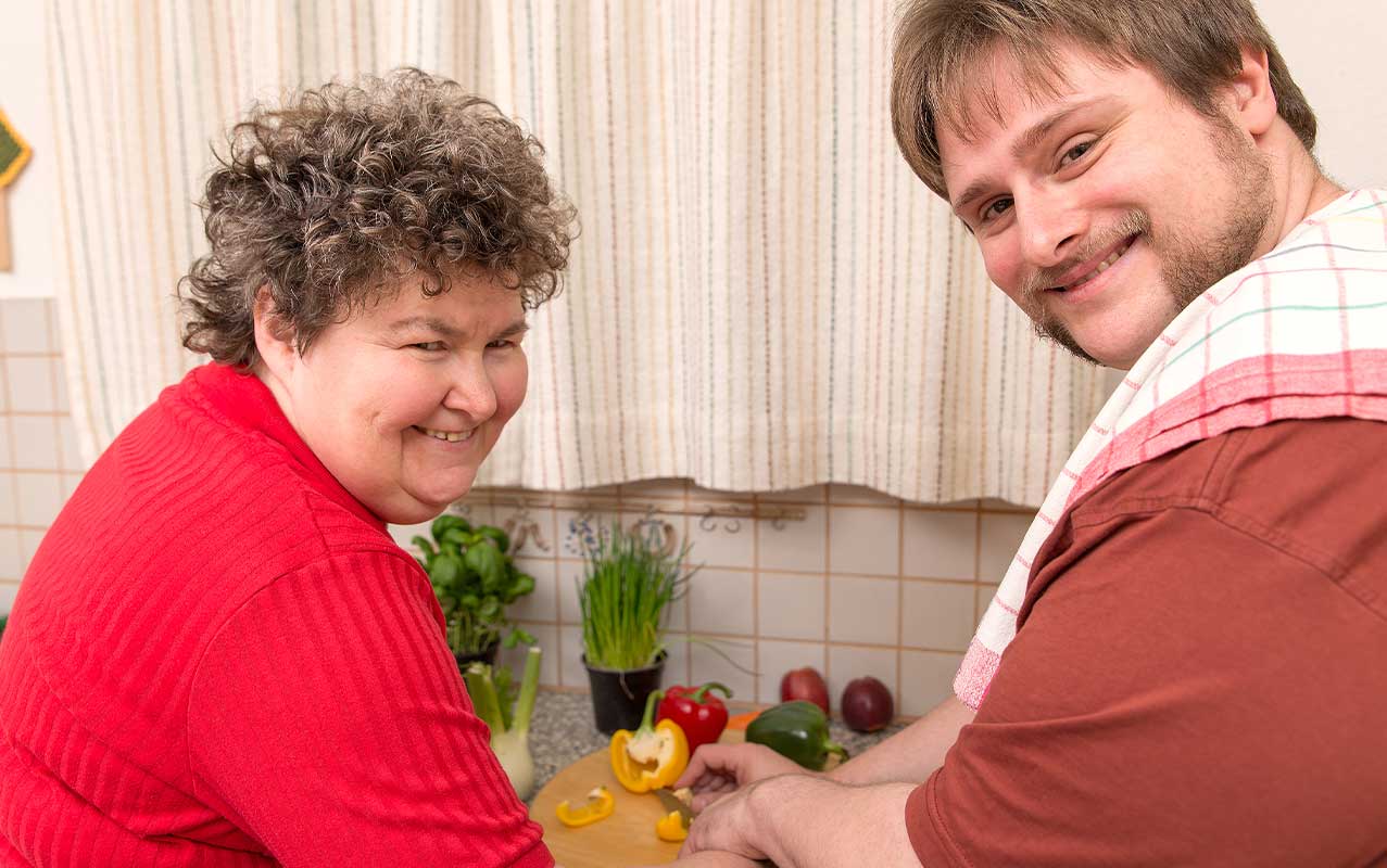 couple doing food preparation in the kitchen