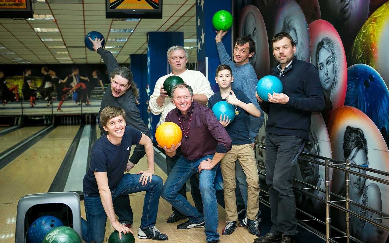 A group of friends posing for a photo at a bowling alley
