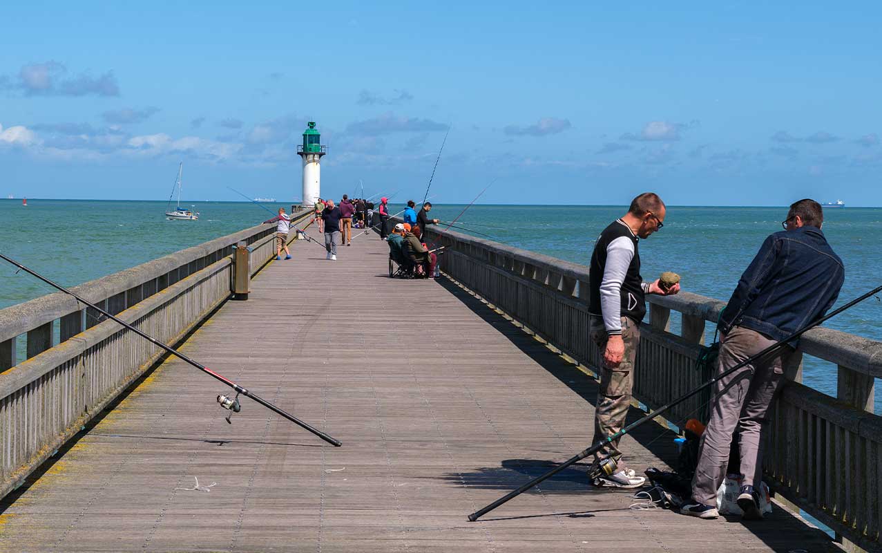 People fishing off a jetty